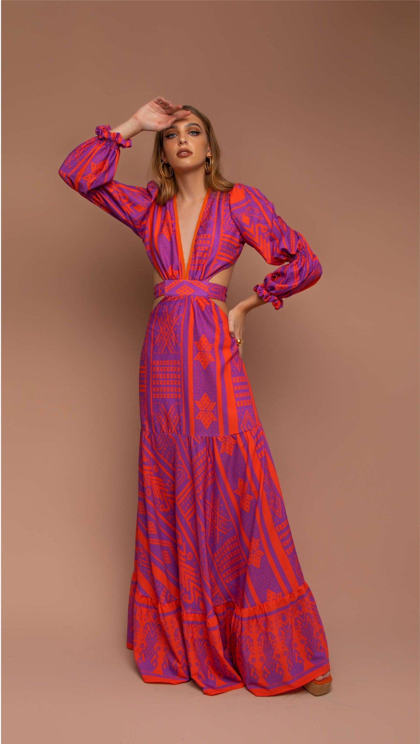 maxi dress in orange and purple pattern with side cutout and open back